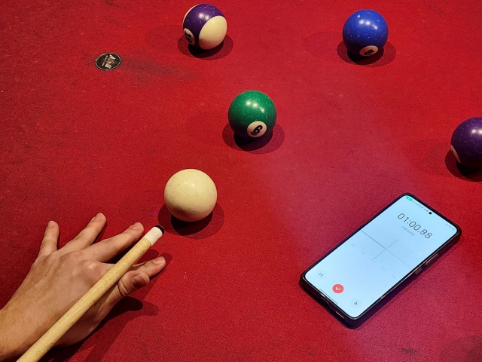  The sharp clack of pool balls colliding