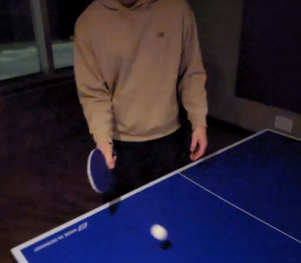 The rhythmic tapping of the ball bouncing on the table